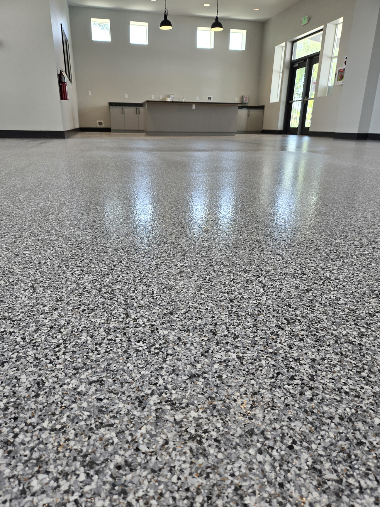 Worn Out Damaged Epoxy Concrete Coating Replaced with Long Lasting Polyaspartic Coating in Louisville Recreation Building